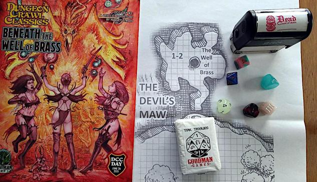 Goodman Games Dungeon Crawl Classics adventure, "Beneath the Well of Brass" on top of a map of the Devil's Maw from the adventure, with some dice, a Death stamp and a pack of TPK tissues.