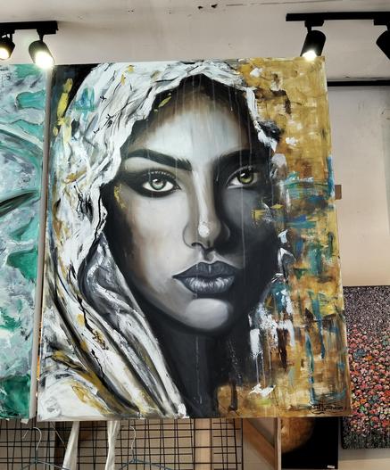 a painting of a woman in  a white veil, abstract impressionist green and gold tones around her, she is looking a the viewer, one pupil black and white, the other amber colored