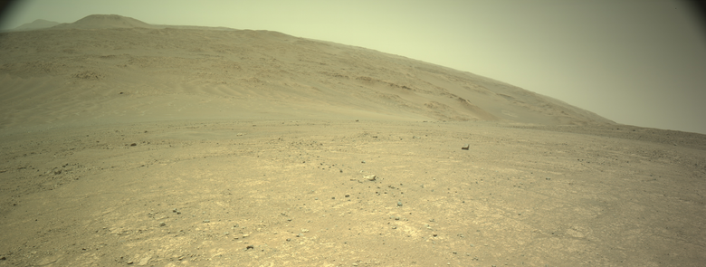 An ochre toned panorama capturing a Martian landscape. This is a stitching of two images captured by the rover's navigation camera.