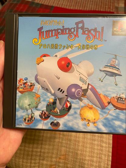 A Japanese import copy of "Jumping Flash!" for the Sony PlayStation 1. I recommend getting a Japanese copy if you can, since it's vastly cheaper than an American copy, with not much of any language barrier present, as dialog is pretty minimal, cutscenes can be figured out by what's happening onscreen, and menus are pretty simple.
