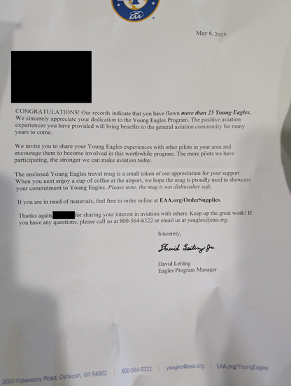 A letter of congratulations from EAA stating that I have flown more than 25 Young Eagles and they have enclosed a travel mug as a token of appreciation.