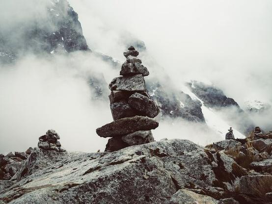 A pile of balanced rocks in the mist.