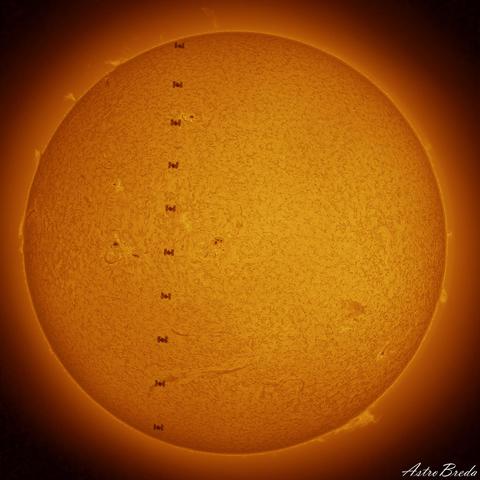 Portrait of the Sun with multiple silhouettes of the ISS as it transits across it.