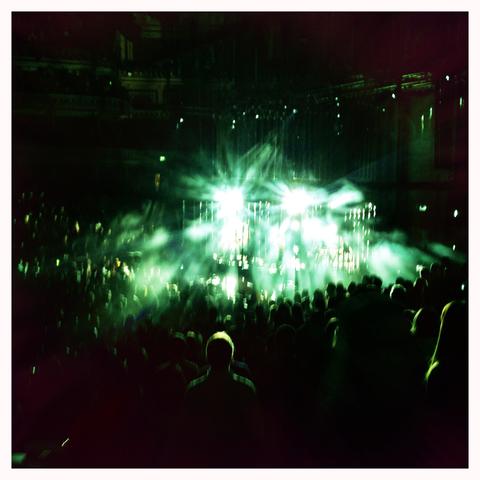 picture taken during an Alt-J concert in the Royal Albert Hall. 

Bright green lights dominate the picture, and you can see people standing in front of me.