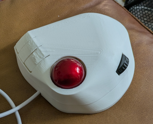 The controller with the cover in place. Printing defects are visible in the area of the buttons.