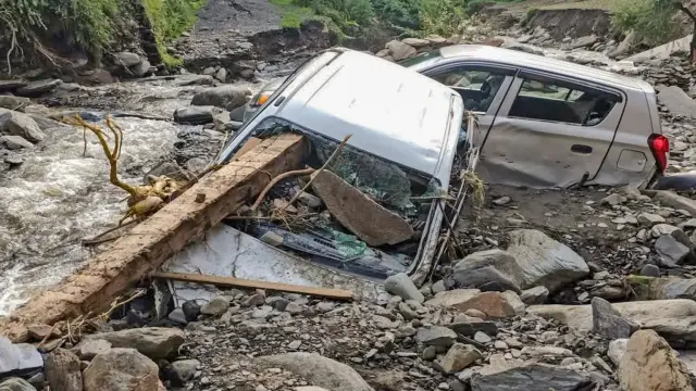 Wrecked cars in flood debris in  somewhere near Mandi.
