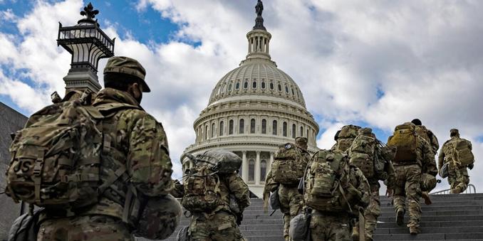 Troops go up the stairs to the U.S. Capitol