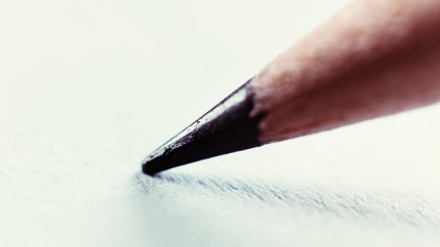Extreme close-up of the end of a pencil resting on a blank sheet of white paper. Extreme close-up of the end of a pencil resting on a blank sheet of white paper.