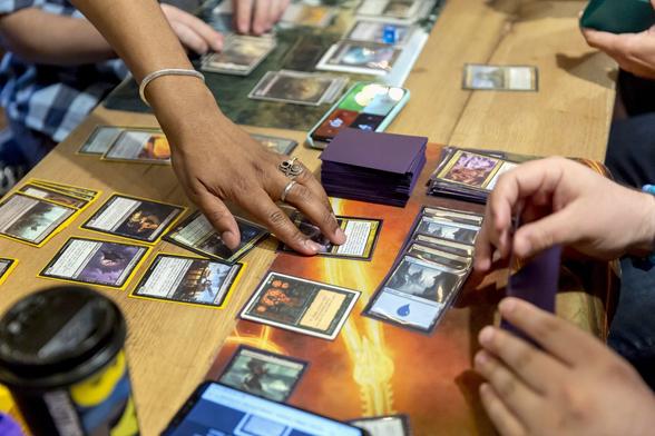 Participants play a Magic: The Gathering card game.