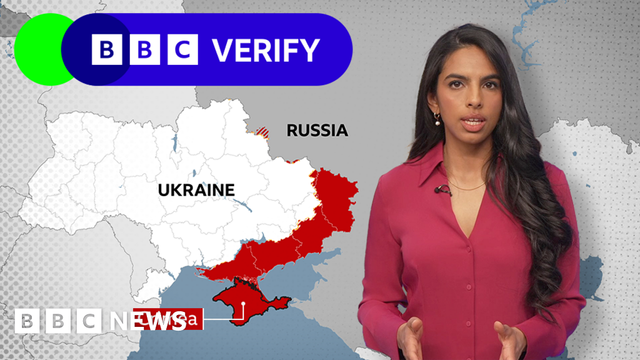 BBC Verify reporter Merlyn Thomas standing in front of a map of Ukraine and Russa, with areas under Russian control highlighted in red