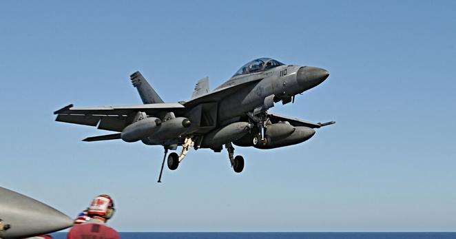 An F/A-18 Hornet fighter jet landing on the deck of the aircraft carrier USS Harry S. Truman in 2022.