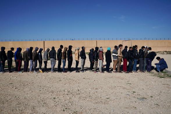 African male detainees at Qanfoodah Detention Center wait in line to be declared present at morning roll call on February 2, 2019, in Benghazi, Libya. African male detainees at Qanfoodah Detention Center wait in line to be declared present at morning roll call on February 2, 2019, in Benghazi, Libya.