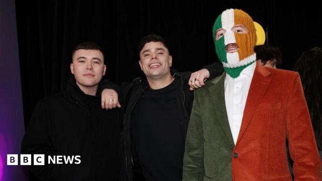 Kneecap members Mo Chara, Moglai Bap and DJ Provai standing together.