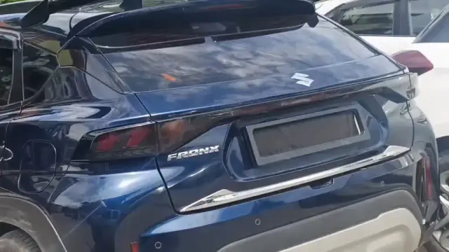 Car with black film covering car number plate, clear violation of traffic rules.