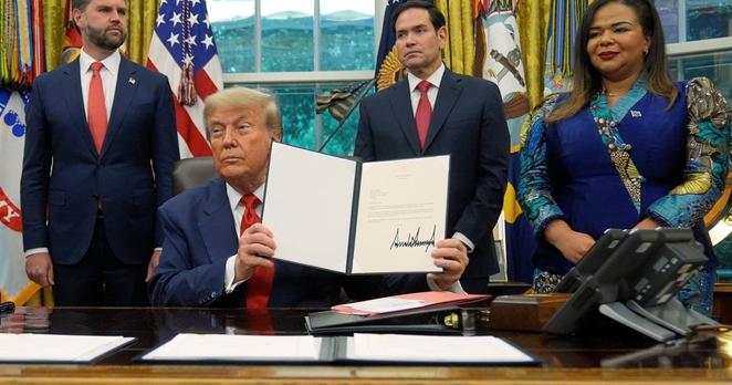Trump holds up a signed document of the Rwanda DRC deal.