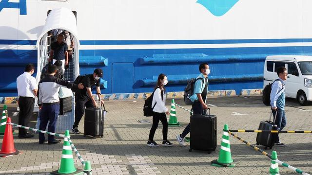 Evacuees from Akuseki-jima Island and Kodakara-jima Island disembark from Ferry Toshima 2 at the Kagoshima Main Port South Pier Ferry Terminal in Kagoshima City, Kagoshima Prefecture on July 6, 2025