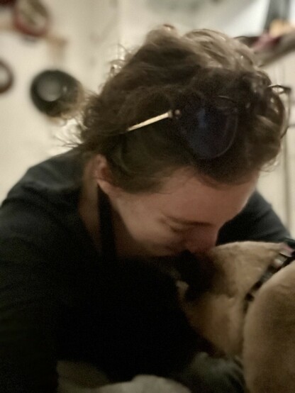 Monkey, a large siamese cat and Very Good Boy, has come over to make sure Kathleen is okay. This is a closeup of the two of them nuzzling their faces together. Kathleen is smiling because she knows that Monkey wants to keep her safe, and she feels so loved. 
