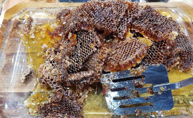 A casserole dish full of comb and honey.