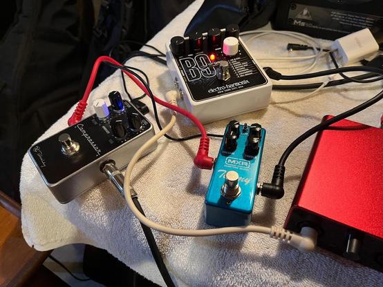 Guitar effects pedals on table. Keeley Compressor, EHX B9 and MXR Timmy