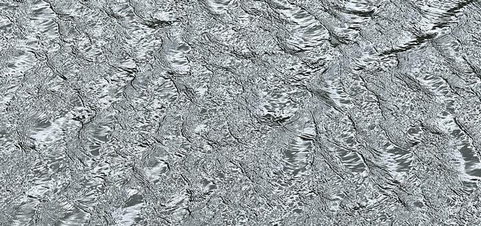 A view of wind-induced ripples on a river. The colours appear in the grey-scale even though the image is in full colour. The length-scale of the image is also not obvious from the patterning; the irregular and criss-cross patterns span the entire image, which captures about 3 meters of view. [Manuels (NL, Canada) June 2025]