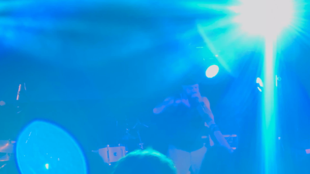 Band member playing didgeridoo 