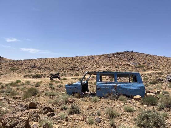 Wreck of a blue transit van in the desert