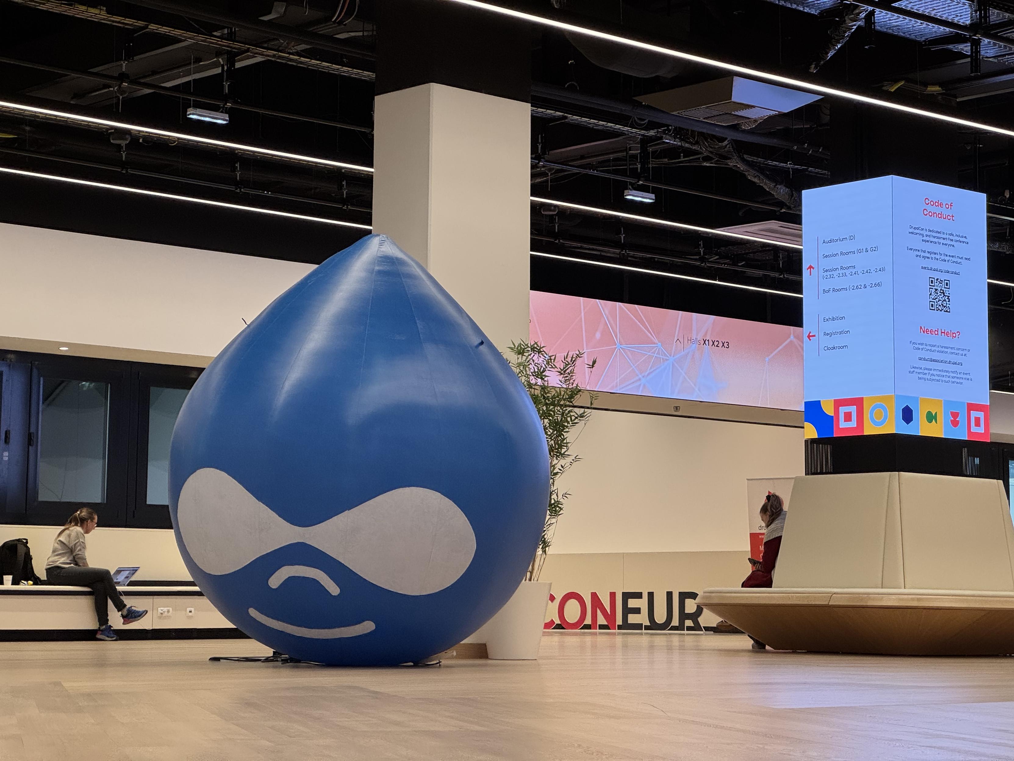 A large inflatable Druplicon, about 2 meters tall, in the hallway.