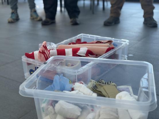 The most awesome box of props ever. There’s various false limbs in a plastic box, each covered in fake blood and bandages