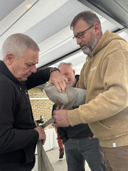Two people applying field dressings to an artificial limb