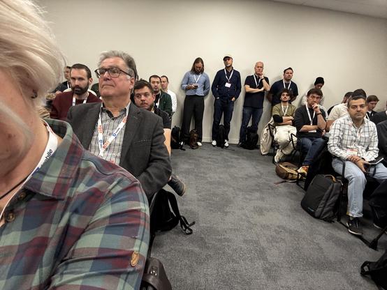 Looking aback across the people sat in the room