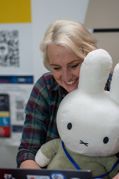 Miffy the DrupalCon mascot, a stuffed rabbit, in front of a MacBook 