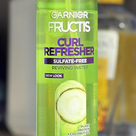 A green bottle of hair nutrient spray called Curl Refresher