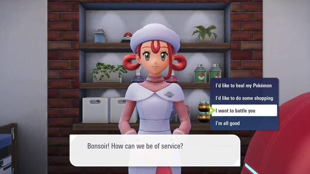 A Pokemon Center nurse looks at you and says Bonsoir! How can we be of service? You have the option to say I'd like to heal my Pokemon, I'd like to do some shopping, a currently highlighted option: I want to battle you, and a final option that is I'm all good.