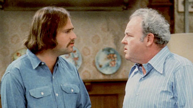 Meathead (Rob Reiner) and Archie Bunker (Carroll O'Connor) looking at each other, probably arguing.