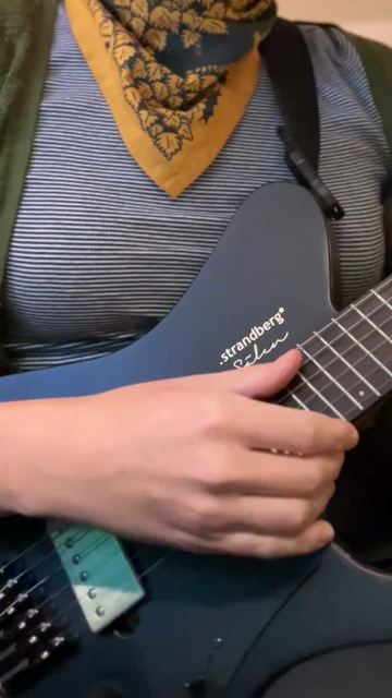 Lex playing a black electric guitar and singing the beginning of Televators by The Mars Volta