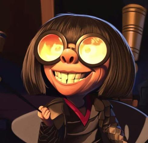 Edna Mode from "The Incredibles" smiling quite large while flames are reflected in her glasses.