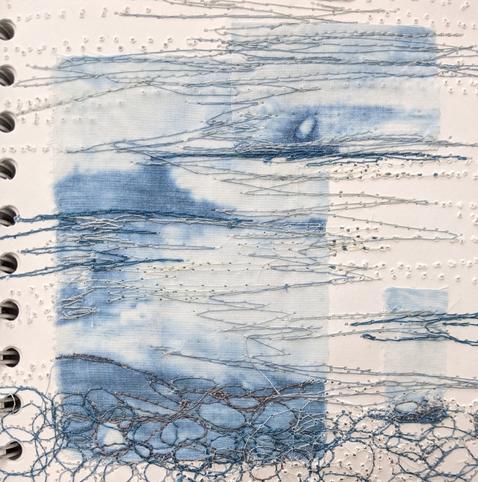 3 small pieces of blue and white fabric stitched onto a sketchbook page with free machining. Abstract seascape/water.