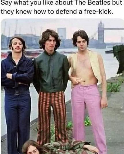 Picture of the Beatles. Three of them are standing in a line and one (Lennon) is lying on the floor in front of them. The caption above says “Say what you like about The Beatles but they knew how to defend a free-kick”