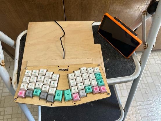 The keyboard attached to the baseboard, with another piece of wood behind it, guiding the USB cable.