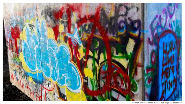 Underground art tagged on a concrete underpass pillar.
