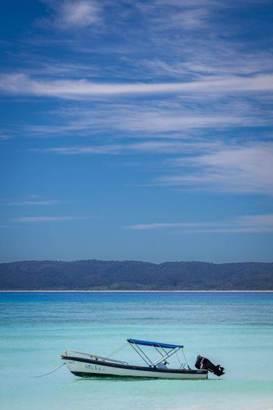 Boat on a beach. Blue skies. Summer mood.