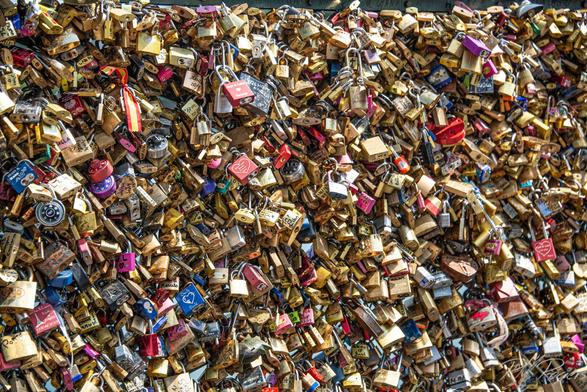 Thousands of locks attached to the Pont des Arts bridge in Paris, signifying eternal love.