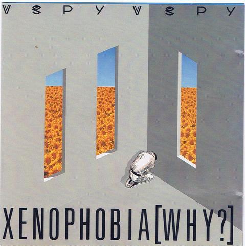 The cover of the V.Spy V.Spy album "Xenophobia[Why?]" which features the corner of a very grey room that has two slender but tall windows on the left side and a single tall window on the right.

In the corner a presumably male person is kneeling, cowering in an almost foetal position with their head tucked in.

Through the three tall windows a bright blue sky can be seen over a field of sunflowers.