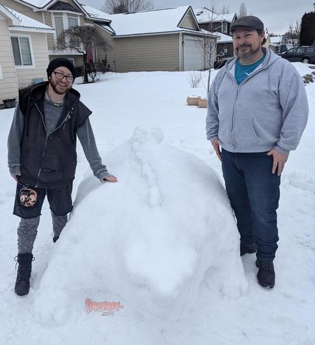 My partner and i next to the ankylosaurus snow sculpture, so you can see it comes up to our waists and we could both ride it at the same time if it was real
