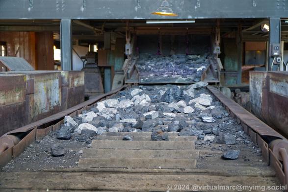 Closeup photo from the conveyor belt with stone and coal on it.
