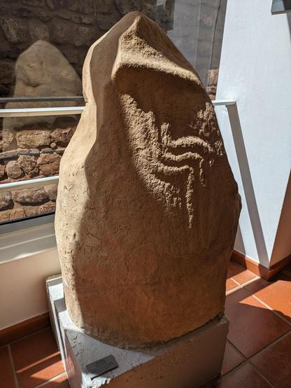 A photograph of a carved menhir (standing stone) from Caramujeira, Algarve (Portugal) - kept in the archaeological museum in Silves