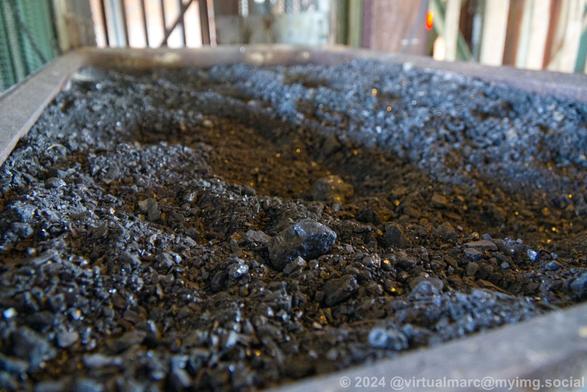 Closeup photo of crushed coal in a minecart.