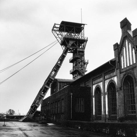 Black and white photo of the headframe of shaft II and part of the pithead bath building at Zollern colliery in Dortmund.
