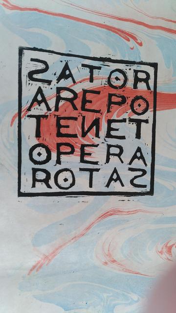 A SATOR magic square lino-printed in black over pale blue and red marbled paper