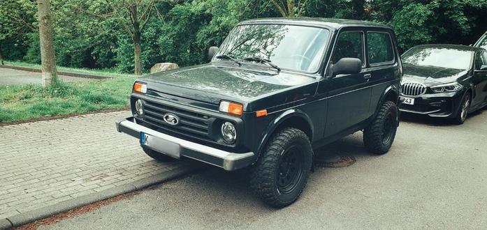 black Lada Niva with brand new offroad tires and generally in great shape